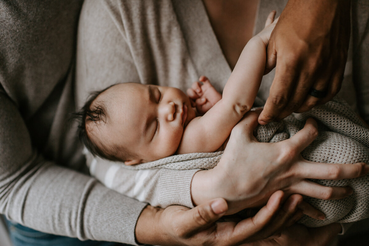 Newborn Photographer, close up of newborn in parents' arms