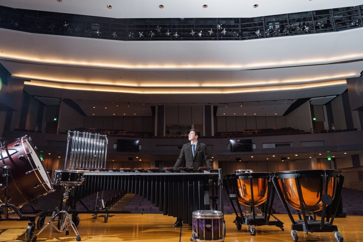 a high school senior posing next to musical instruments