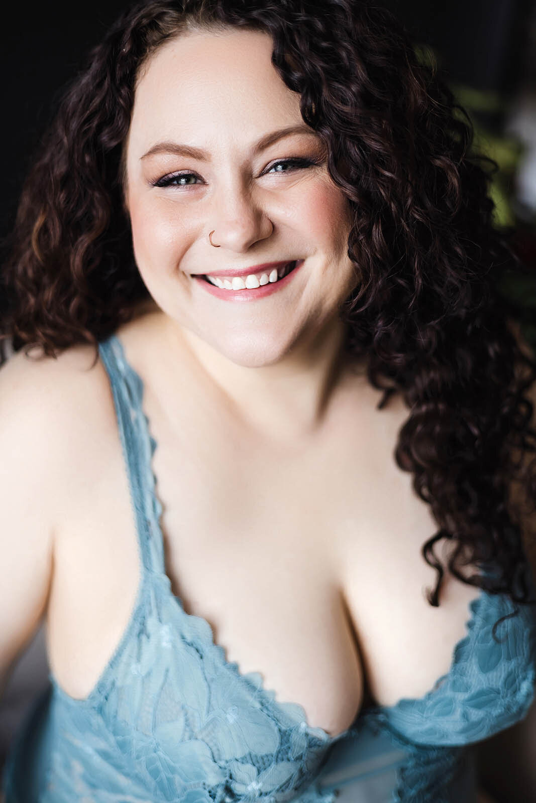 A happy woman poses for a Vancouver Boudoir Photographer