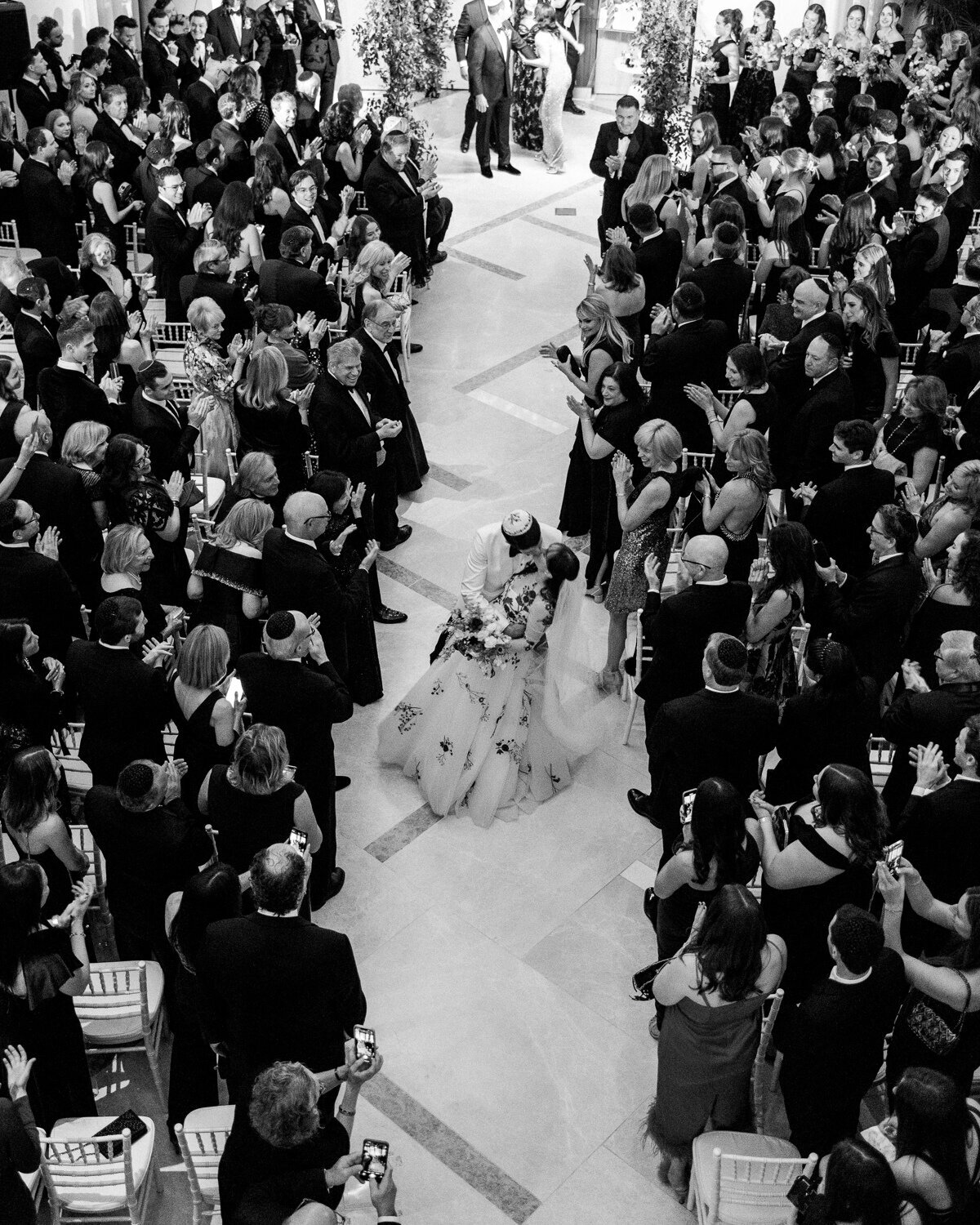 black tie wedding ceremony with colorful chuppah
