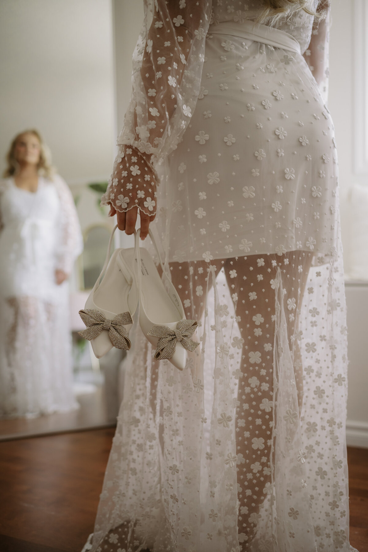 bride holding shoes on wedding morning