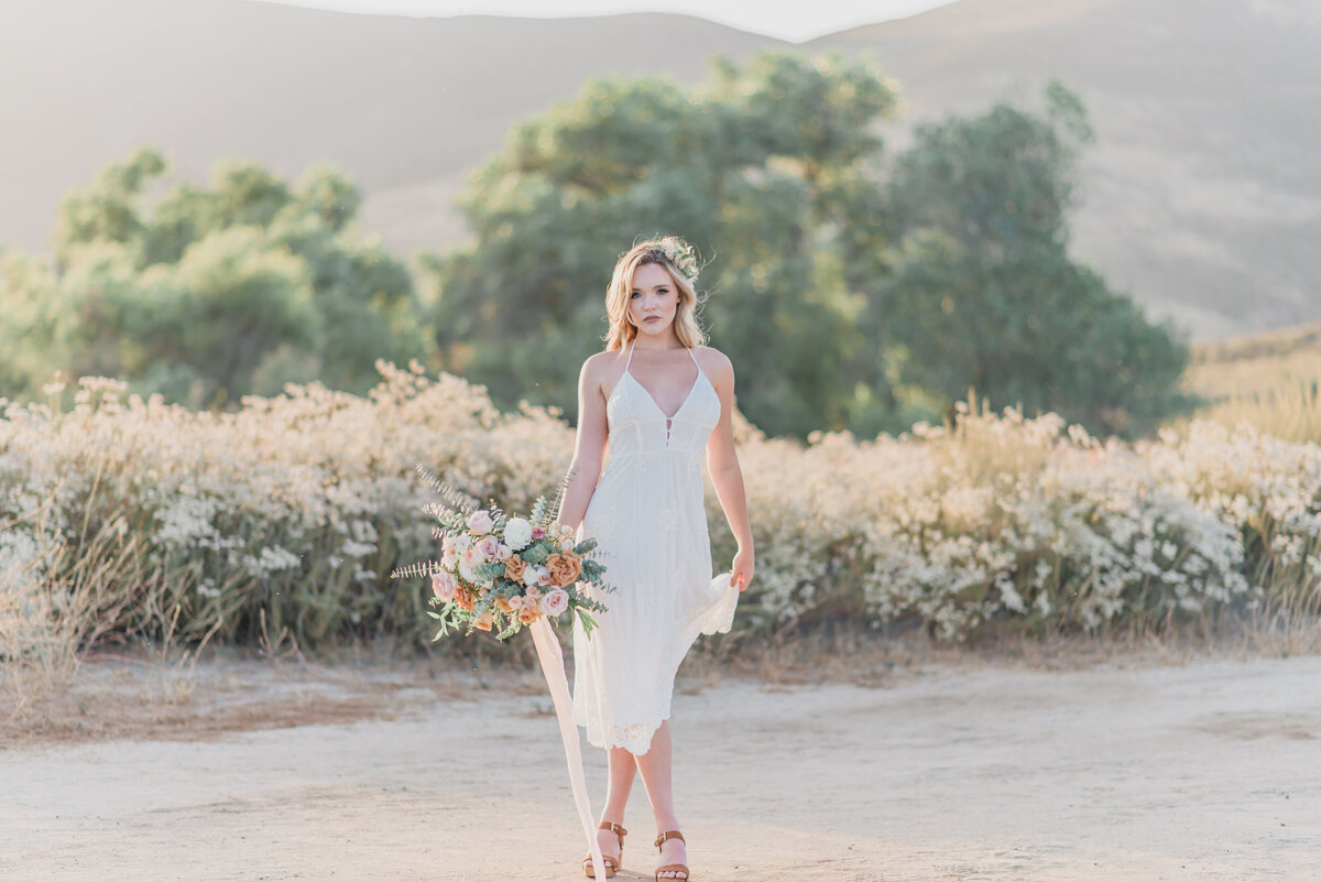 Bride portrait holding bouquet in the fields of Temecula
