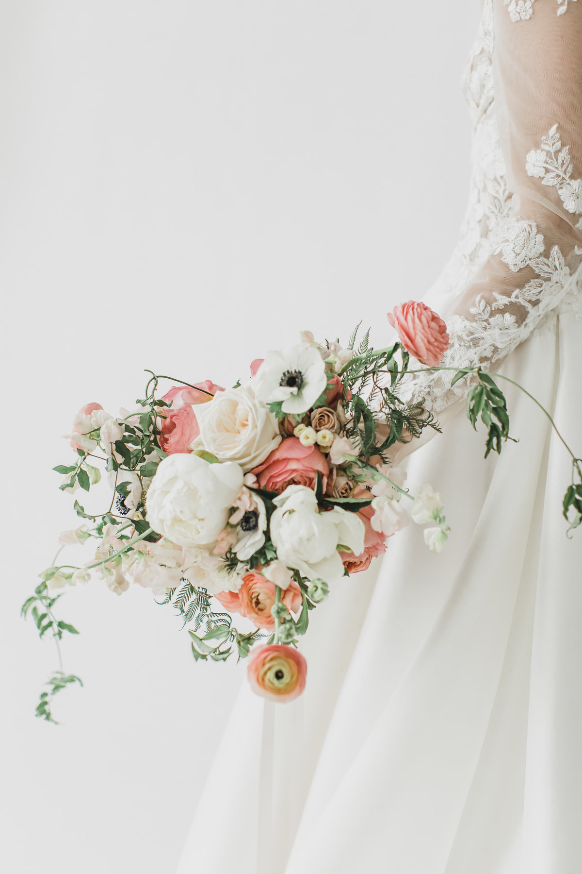 Wedding Photographer & Elopement Photographer bride holds bunch of elegant flowers