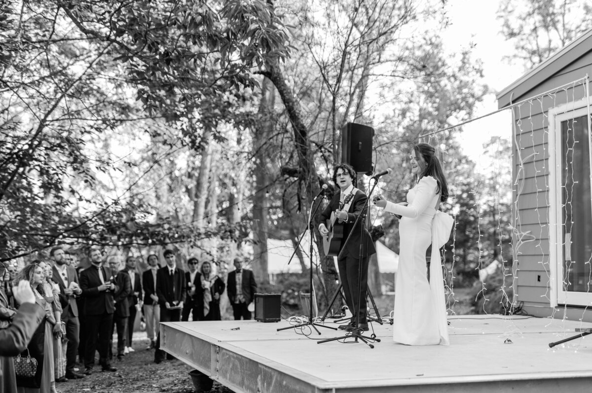 Bride and groom performing on stage at their wedding