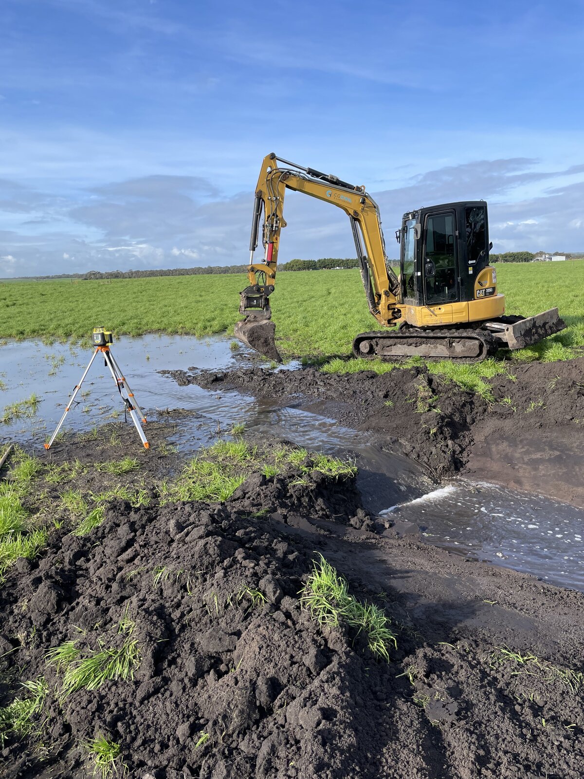 excavator constructing new farm drainage
