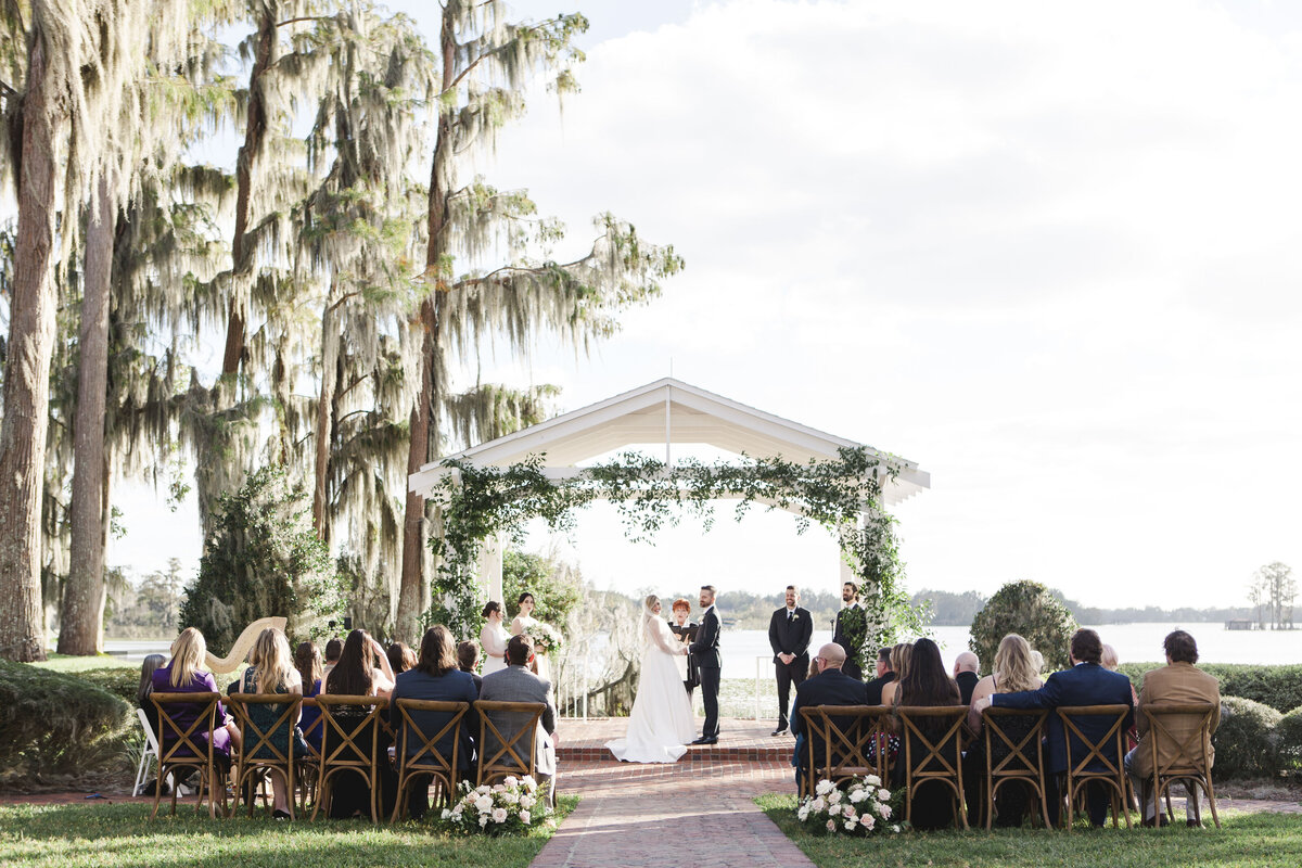 light and airy wedding ceremony cypress grove estate orlando florida bride and groom lakeside