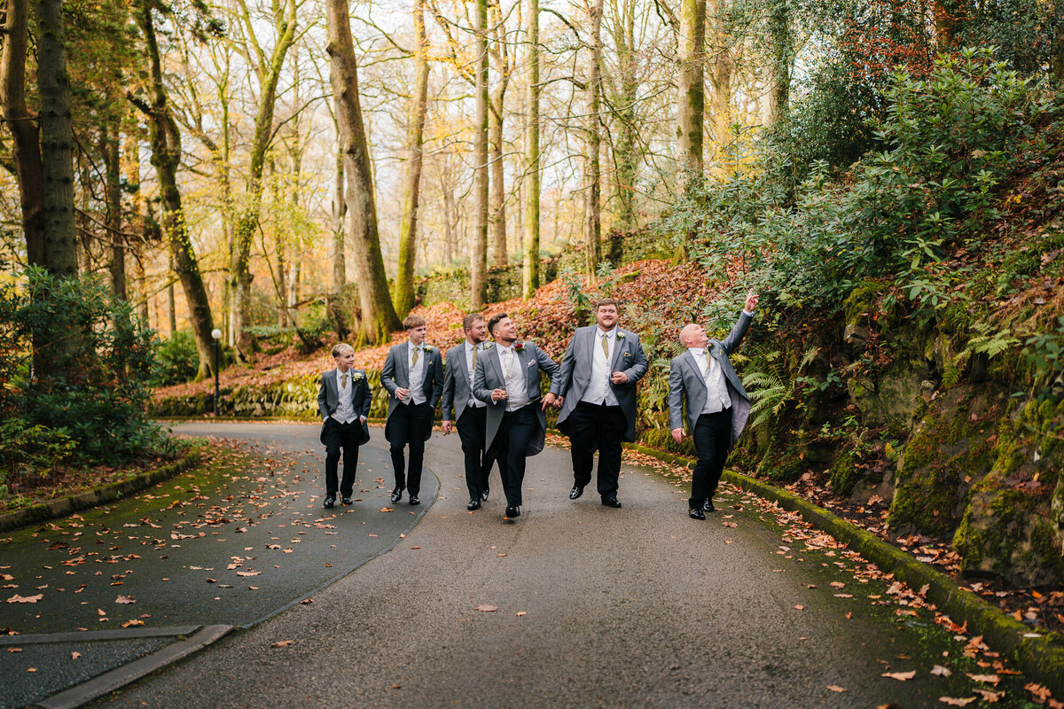Groomsman walking up the drive at Merewood Country House Hotel in the Lake District taken by Anthon y Horseman Wedding Photographer and Videographer