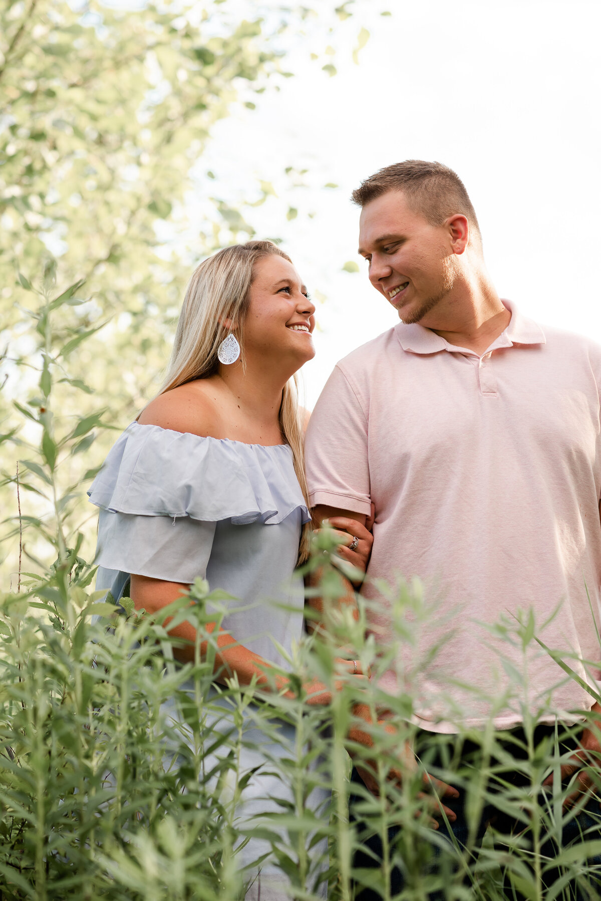 Photos of couple in tall grass taken by Michelle Lynn Photography located near Louisville, Kentucky