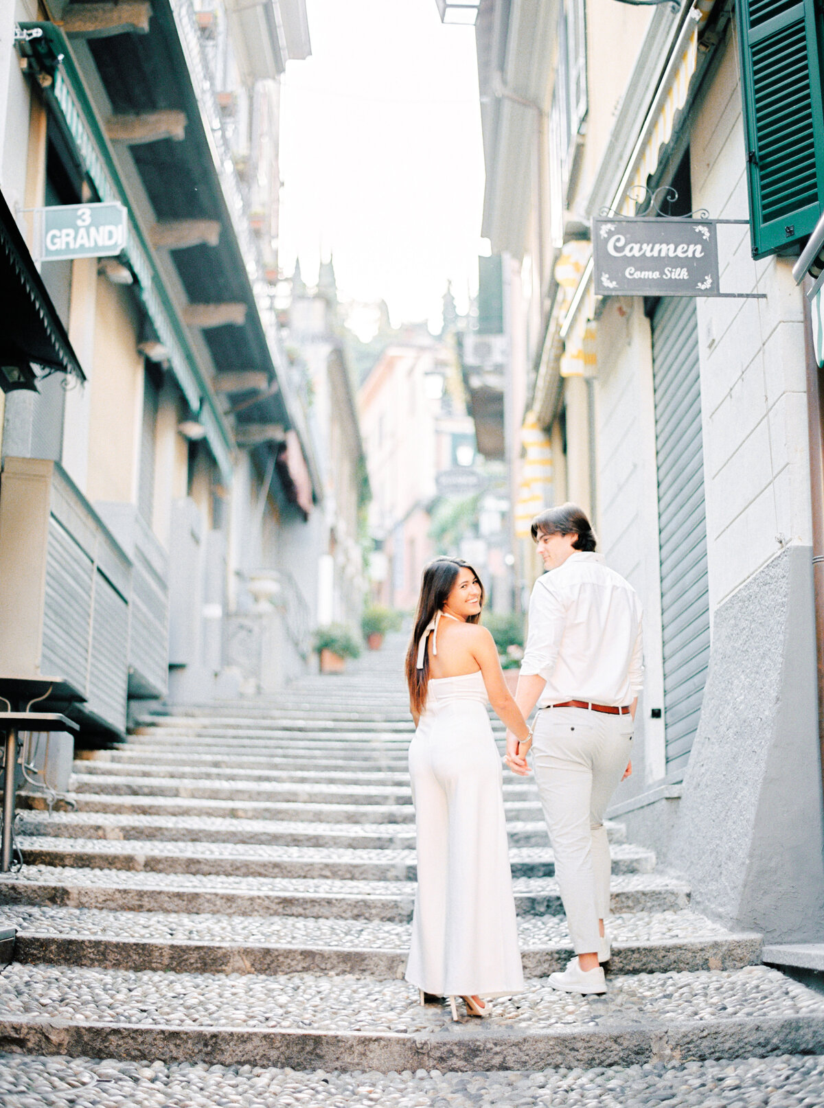 Couple walking up the steps of Belaggio Italy engagement session, photographed by Italy wedding photographer.