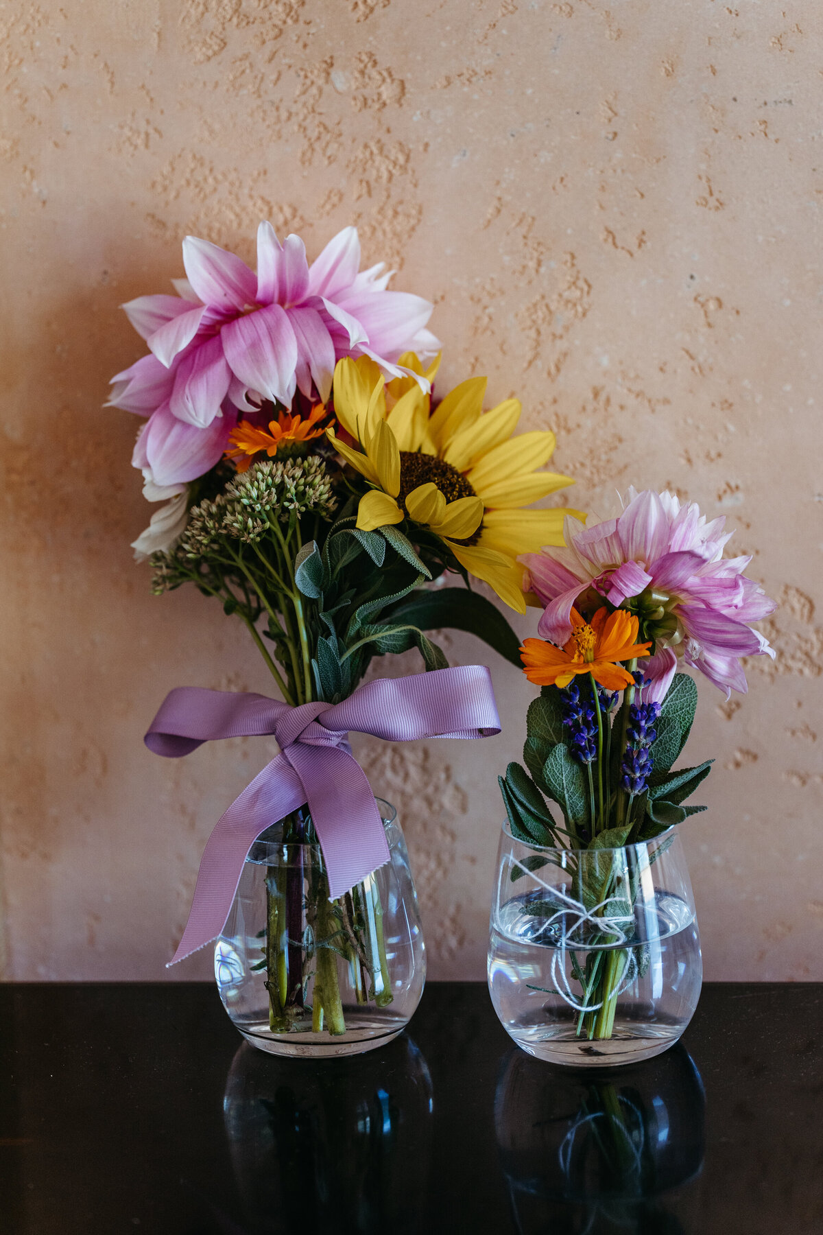 Two glass jars with hand-picked wildflower bouquets