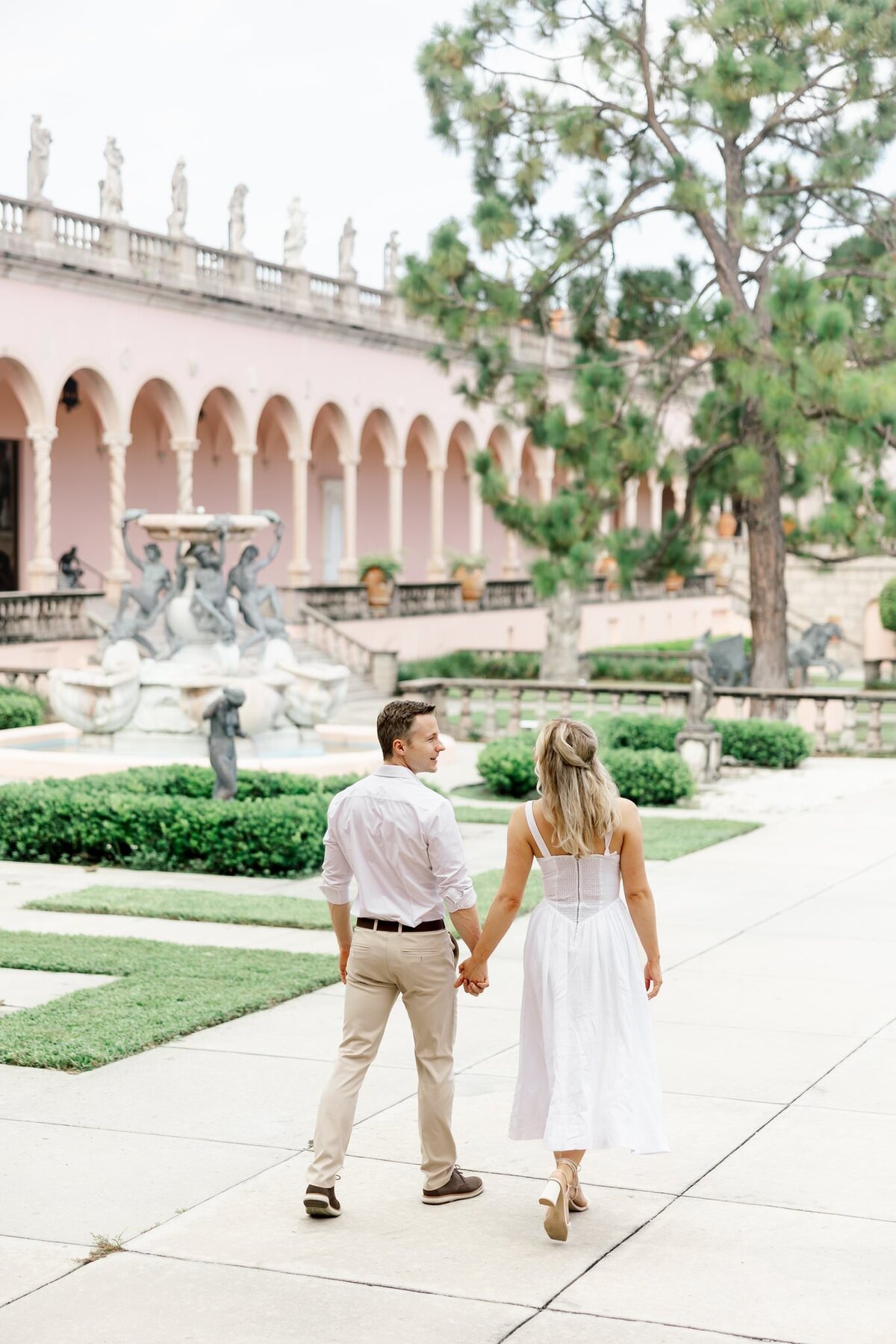couple walking away and looking at each other by wedding photographers in orlando fl