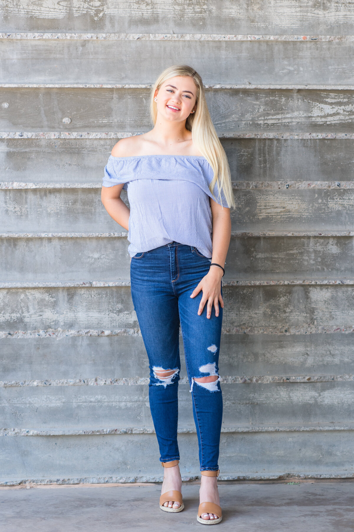 Senior girl standing and smiling for senior photo