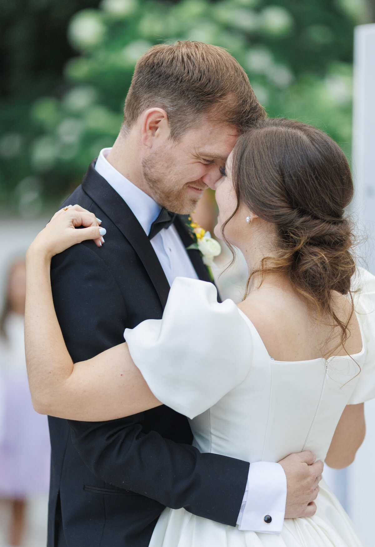 Detail of a bride and groom first dance, embracing