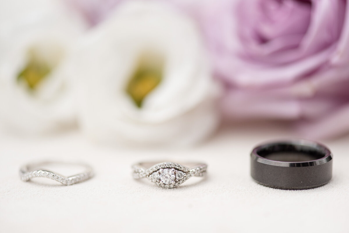 Wedding ring shot with florals in background