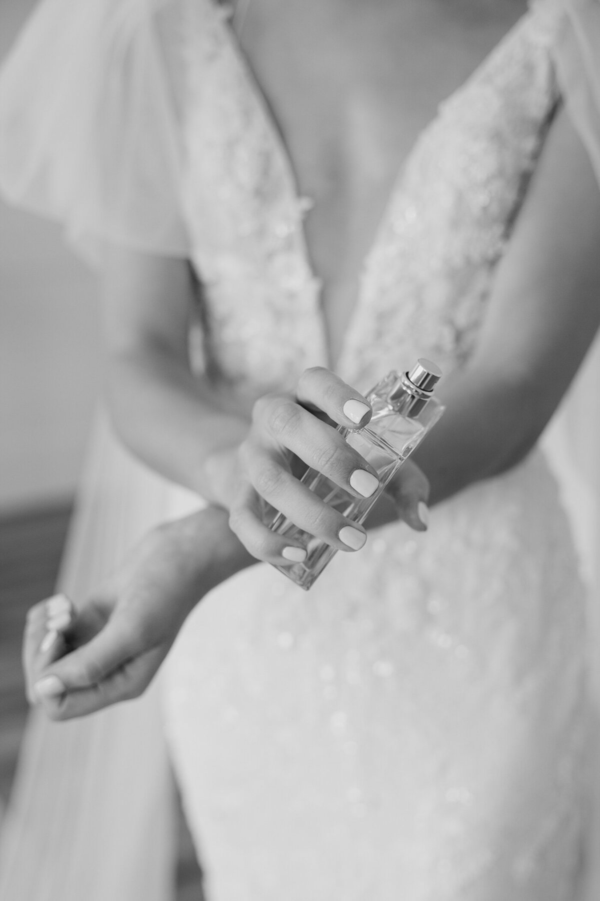 bride putting on perfume as she gets ready the morning of her wedding at Magnolia Hill Farm