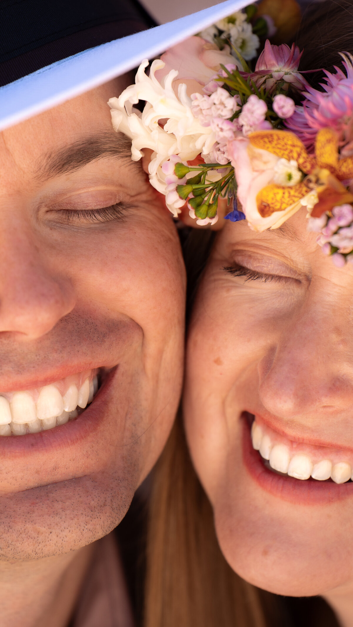 A couple smiling with their faces together