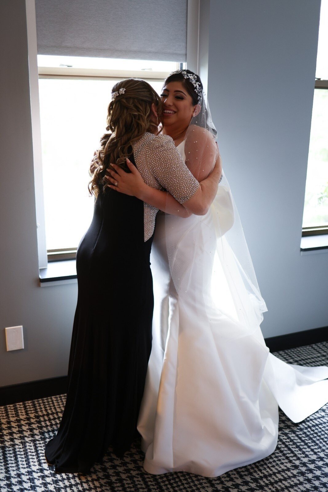 Bride hugs her mother during prep at Union Club Hotel