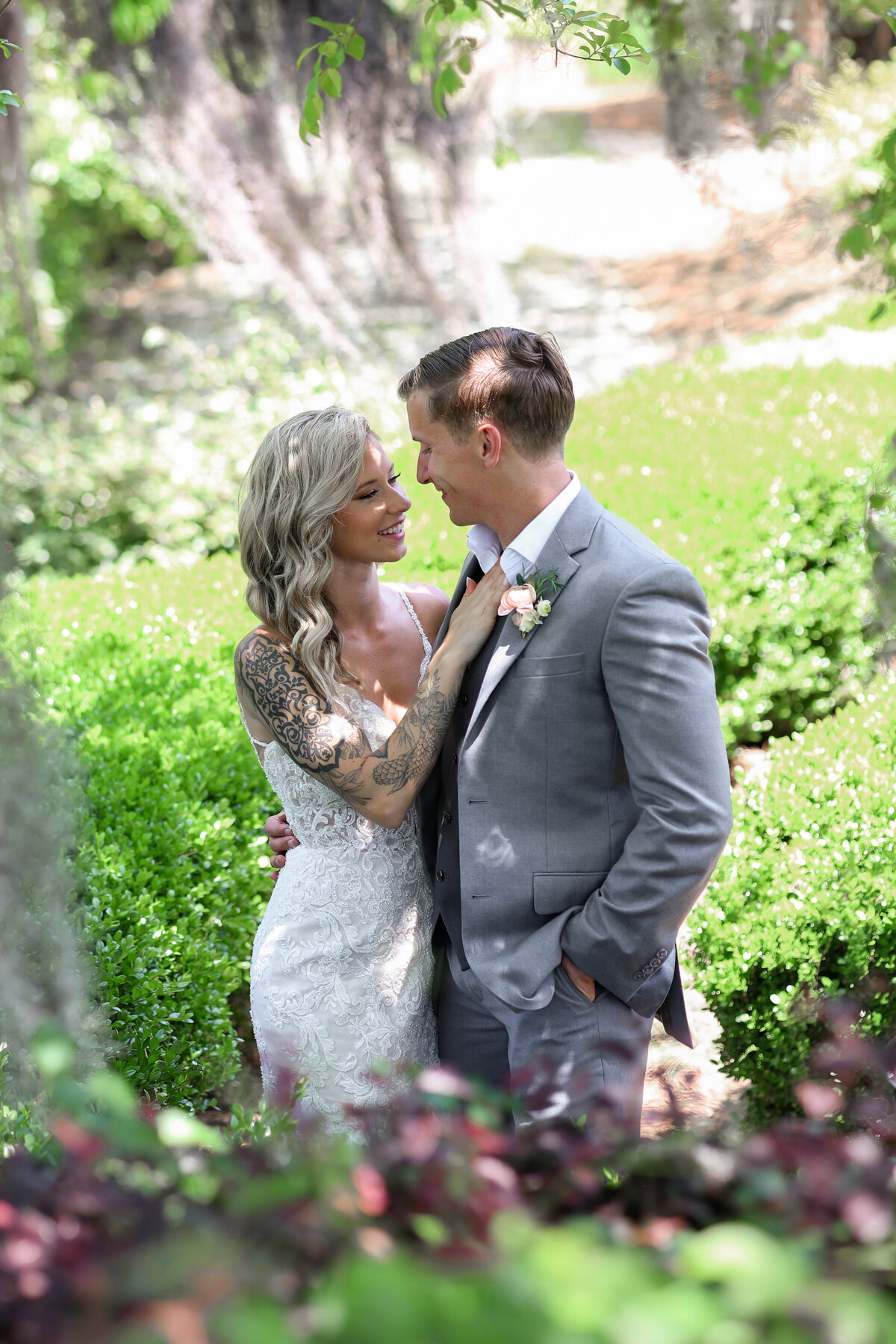 Bride and Groom looking at each  other with spanish moss in the background at The Bibb Mill in Columbus Georgia by Columbus Georgia wedding photographer Amanda Richardson Photography