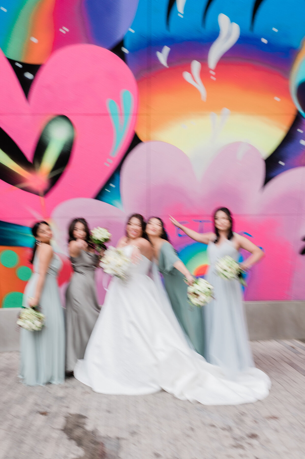 Candid image of bridesmaids outside a colorful NYC mural