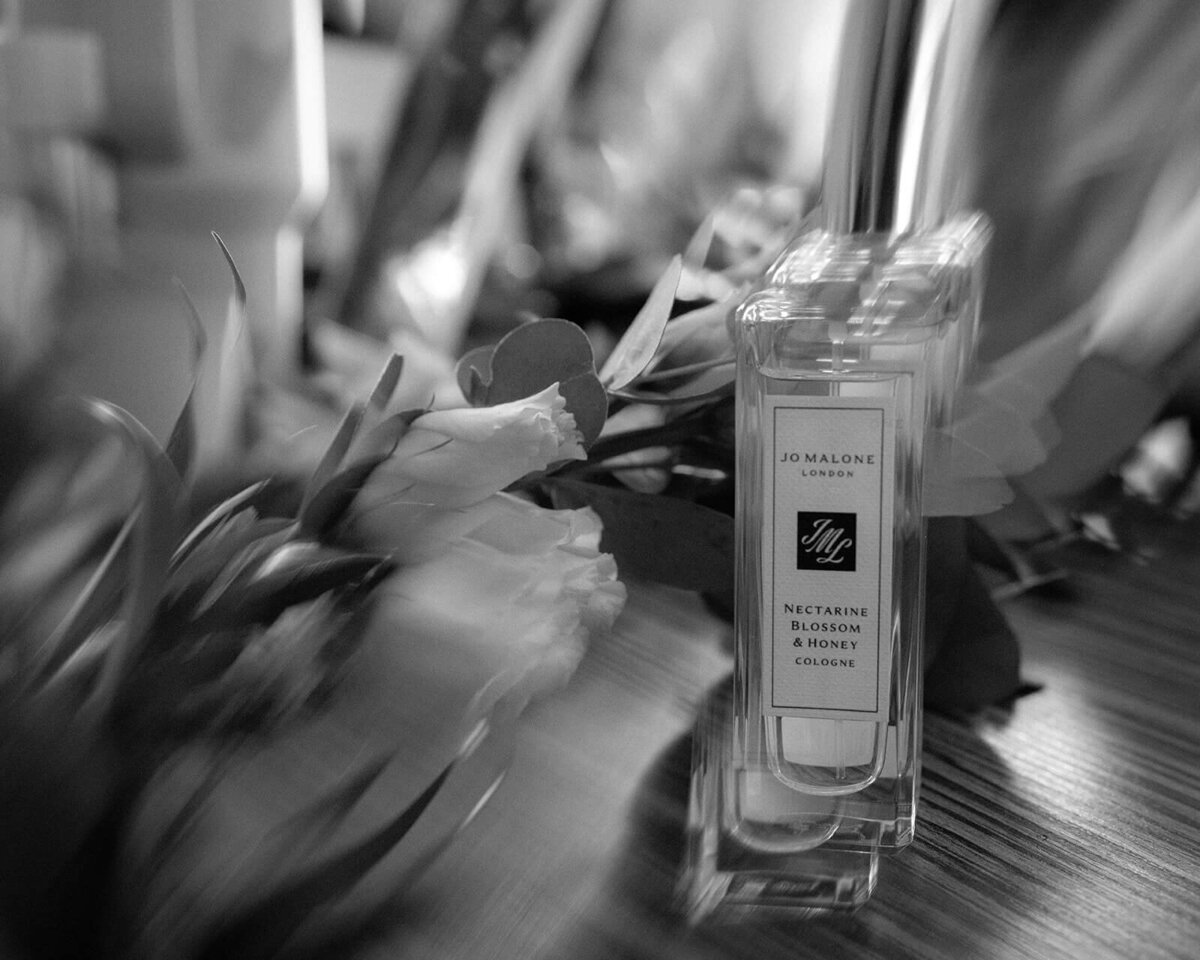 An artistically blurred image of roses and Jo Malone perfume