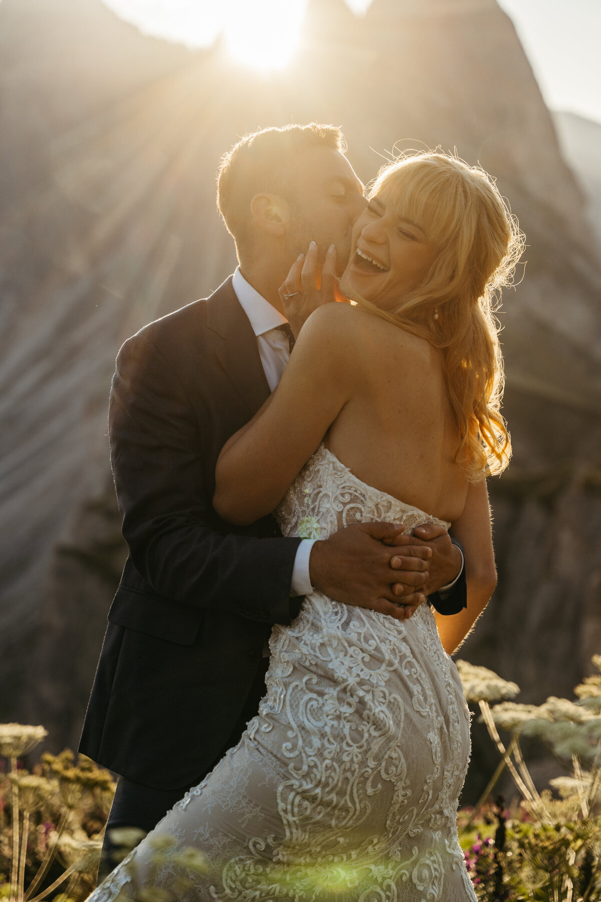Couple hugging in alpine meadow at sunrise Seceda
