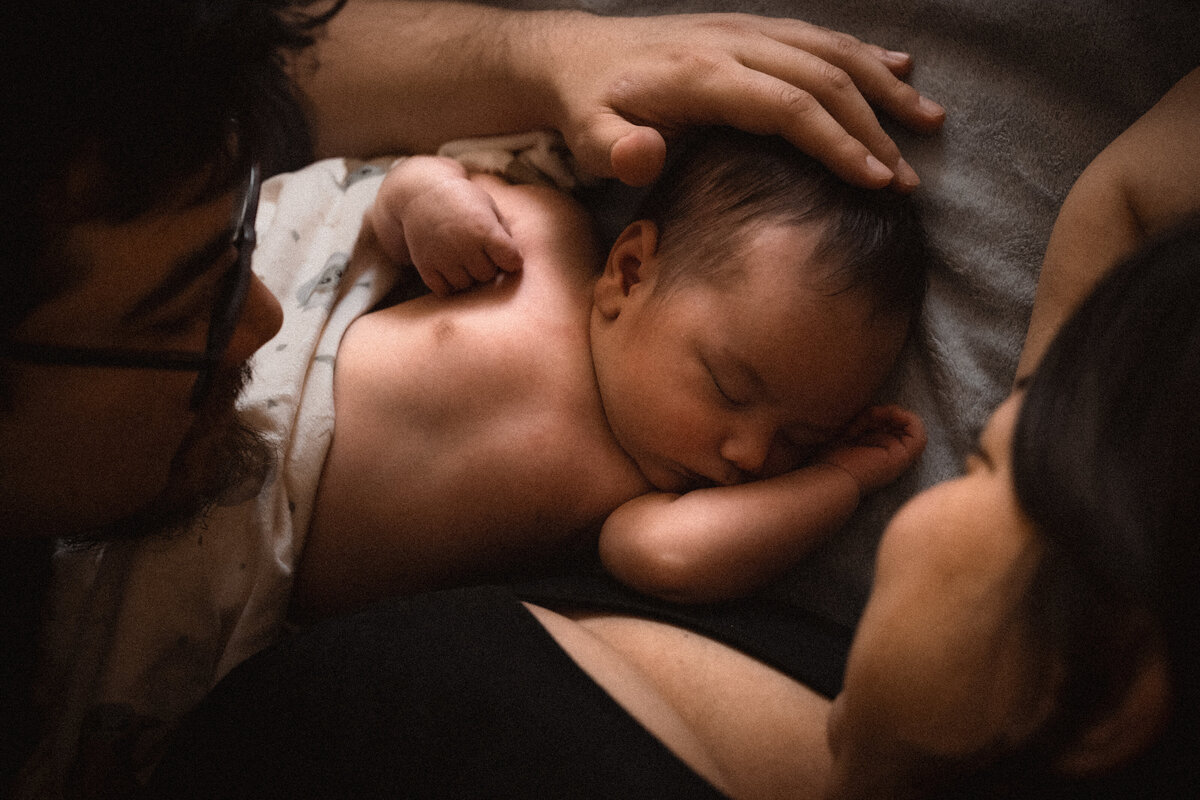 mother and father looking at newborn baby