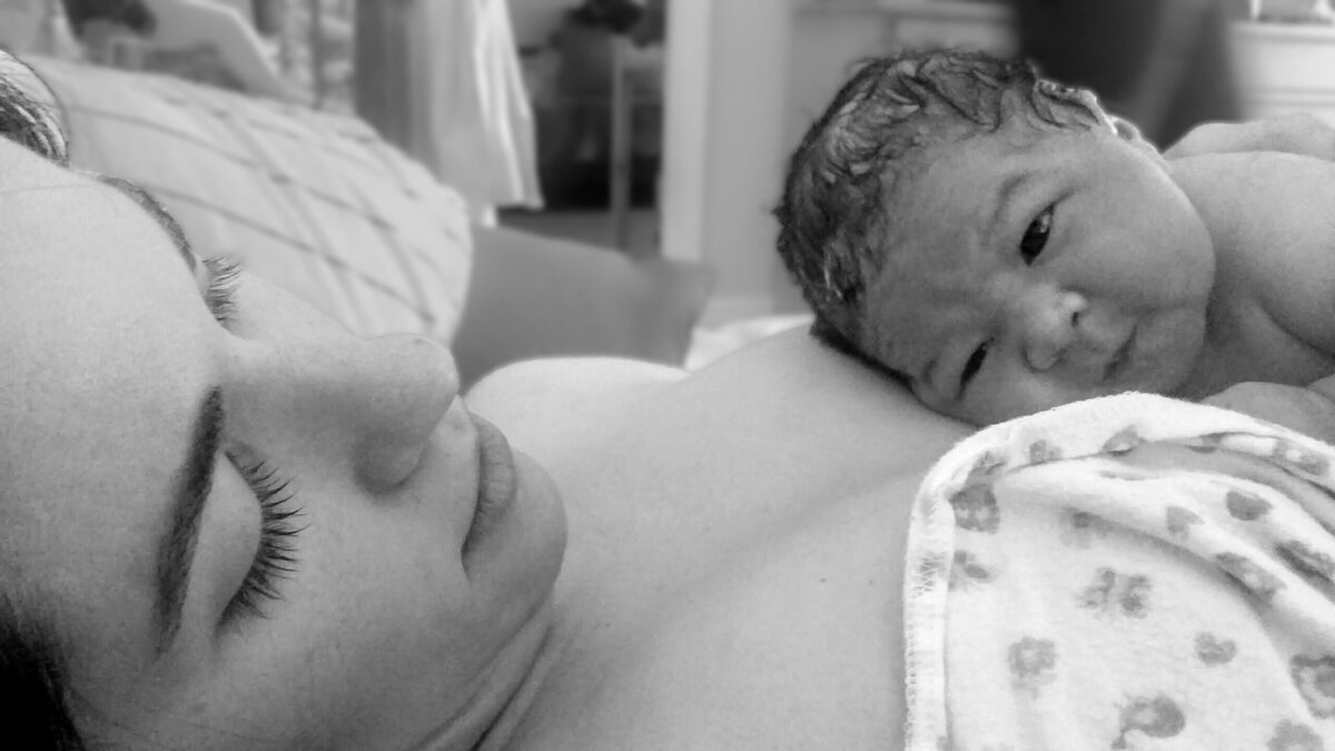 Homebirth family gazing at newborn baby