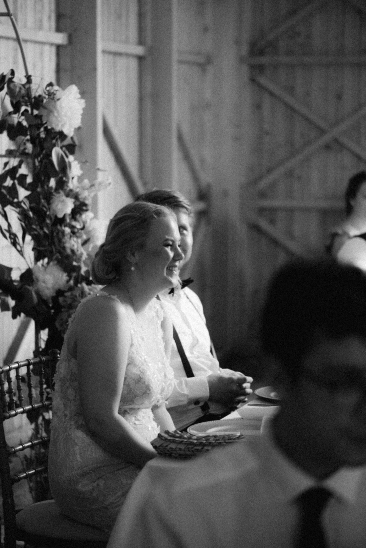 Wedding couple listening to a speechin an image photographed by wedding photographer Hannika Gabrielsson.
