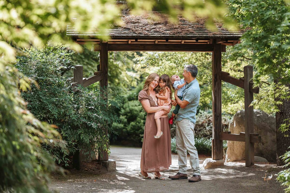 Natural candid of a family enjoying a quiet moment together at Kubota Garden, surrounded by lush greenery.