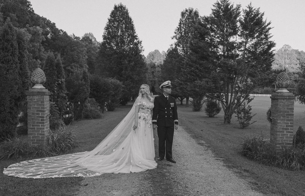 Bride and Groom stand together looking opposite directions