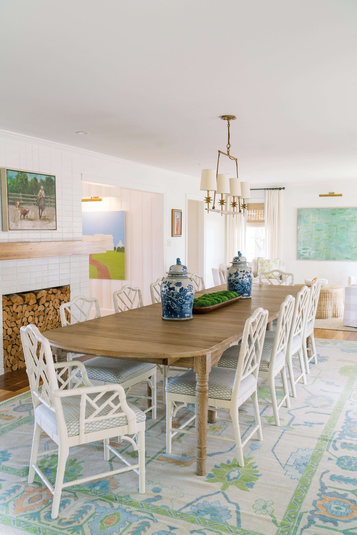 oyster creek studios happy valley white chairs around a wooden dining room table with white and green rug