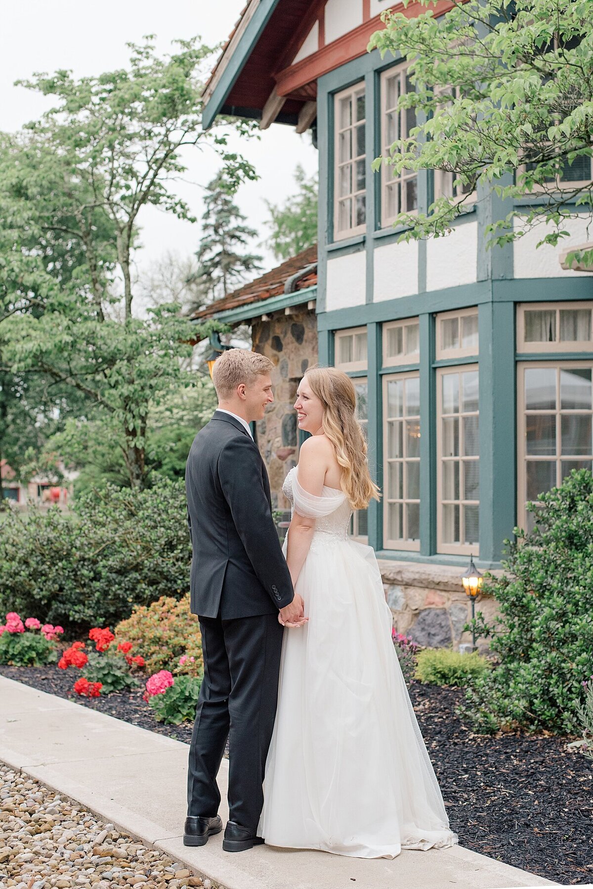 Bride and groom smiling outside of Bevelry Mansion during Ohio wedding