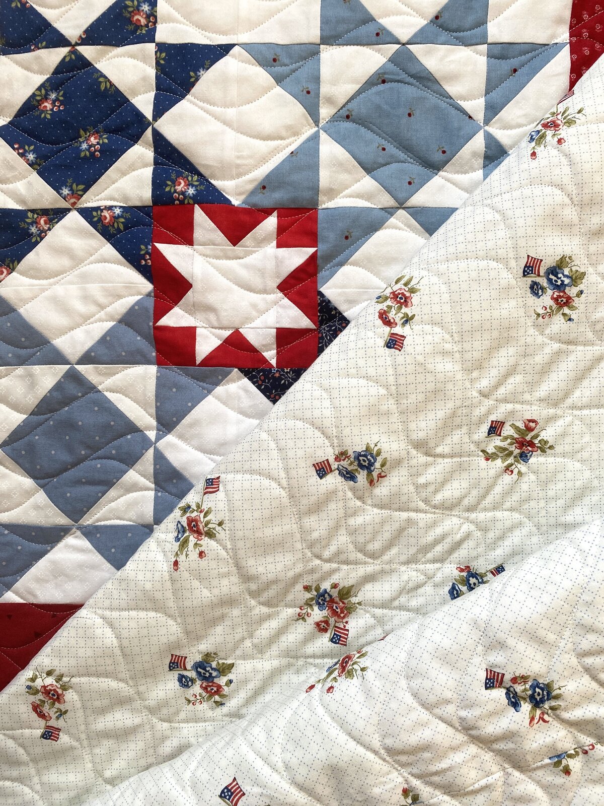 red, blue and white star quilt features the wide and narrow waves quilting design