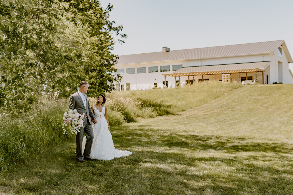 wedding-couple-portrait-venue-in-background-emerald-hills-events-promise-city-iowa-des-moines-wedding-photographer-storyteller-collective-photo-co