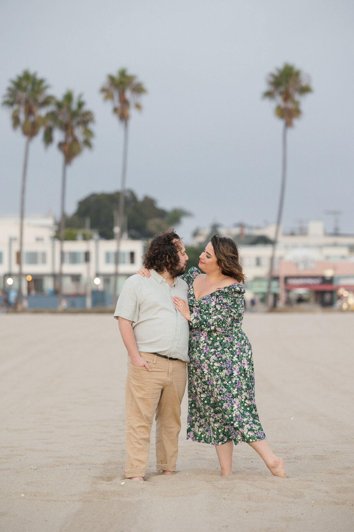 A couple standing in the sand about to kiss