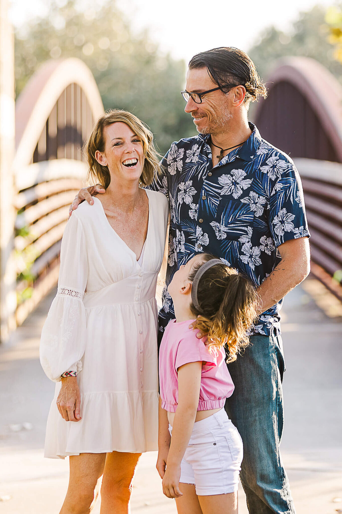 Family laughing near a bridge