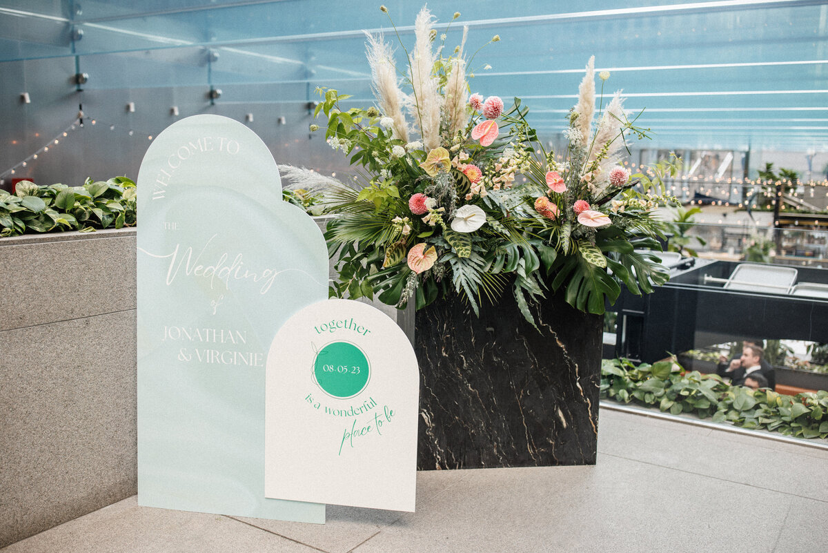 A large exotic flower arrangement decorates a place card display at a wedding reception at Cathcart.