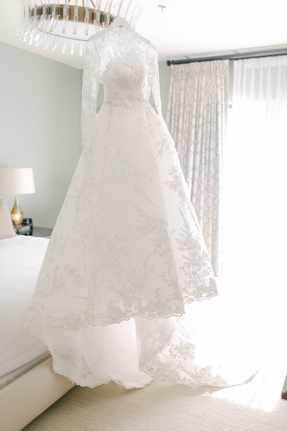 wedding dress hanging from chandelier