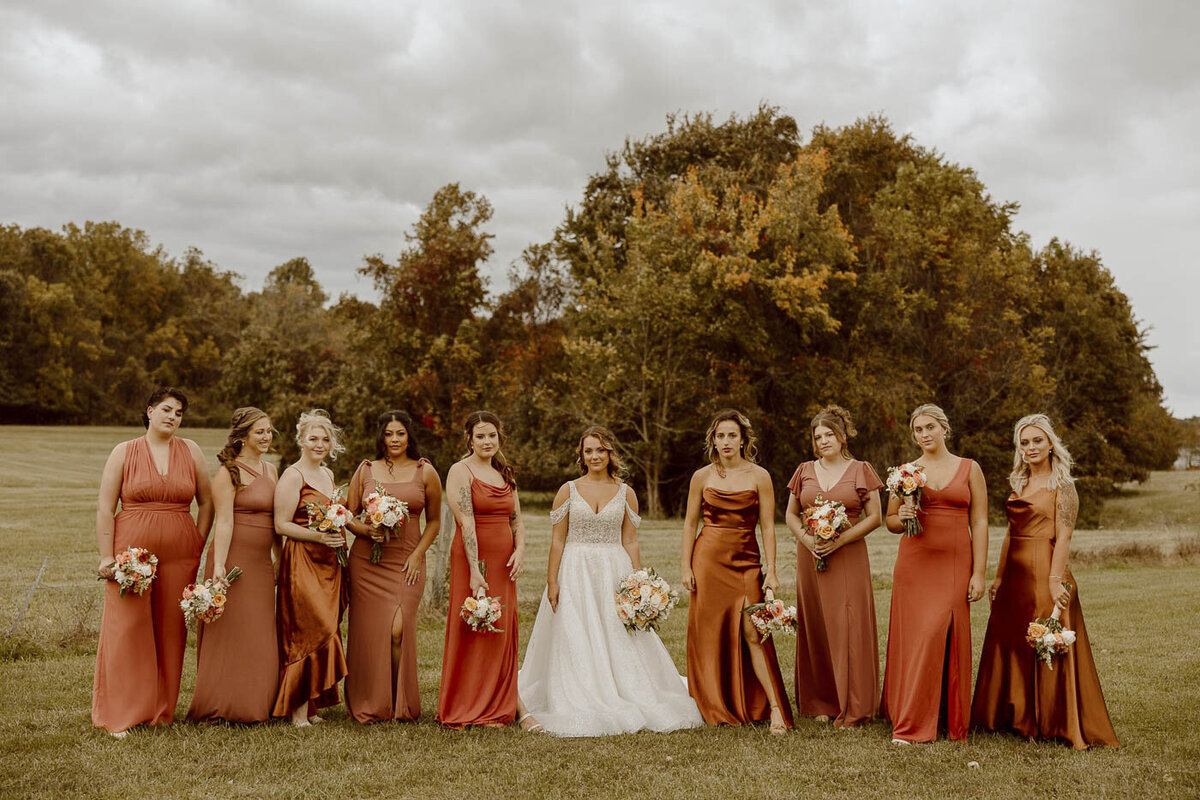 Wedding Bride and Bridesmaids pose and look at camera with model face.