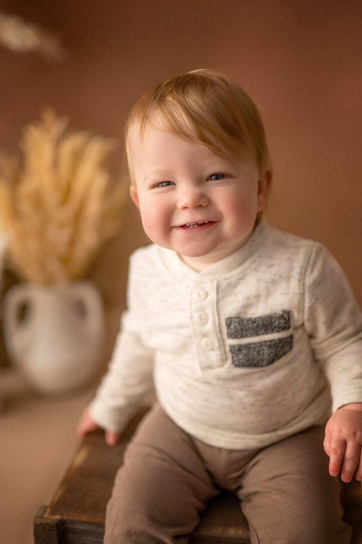 A toddler boy poses in our Waukesha portrait studio.