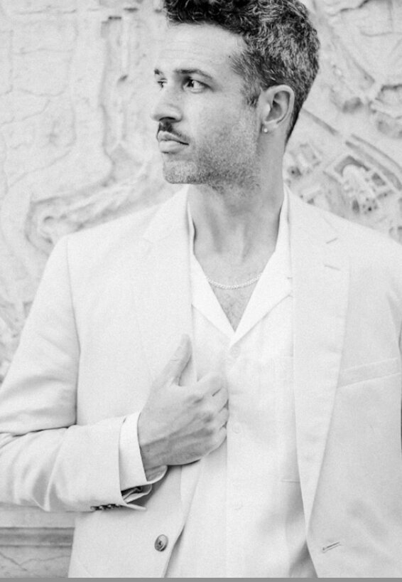 A black-and-white portrait of the groom, exuding elegance and style during their venice, italy engagement session by Christine Grace