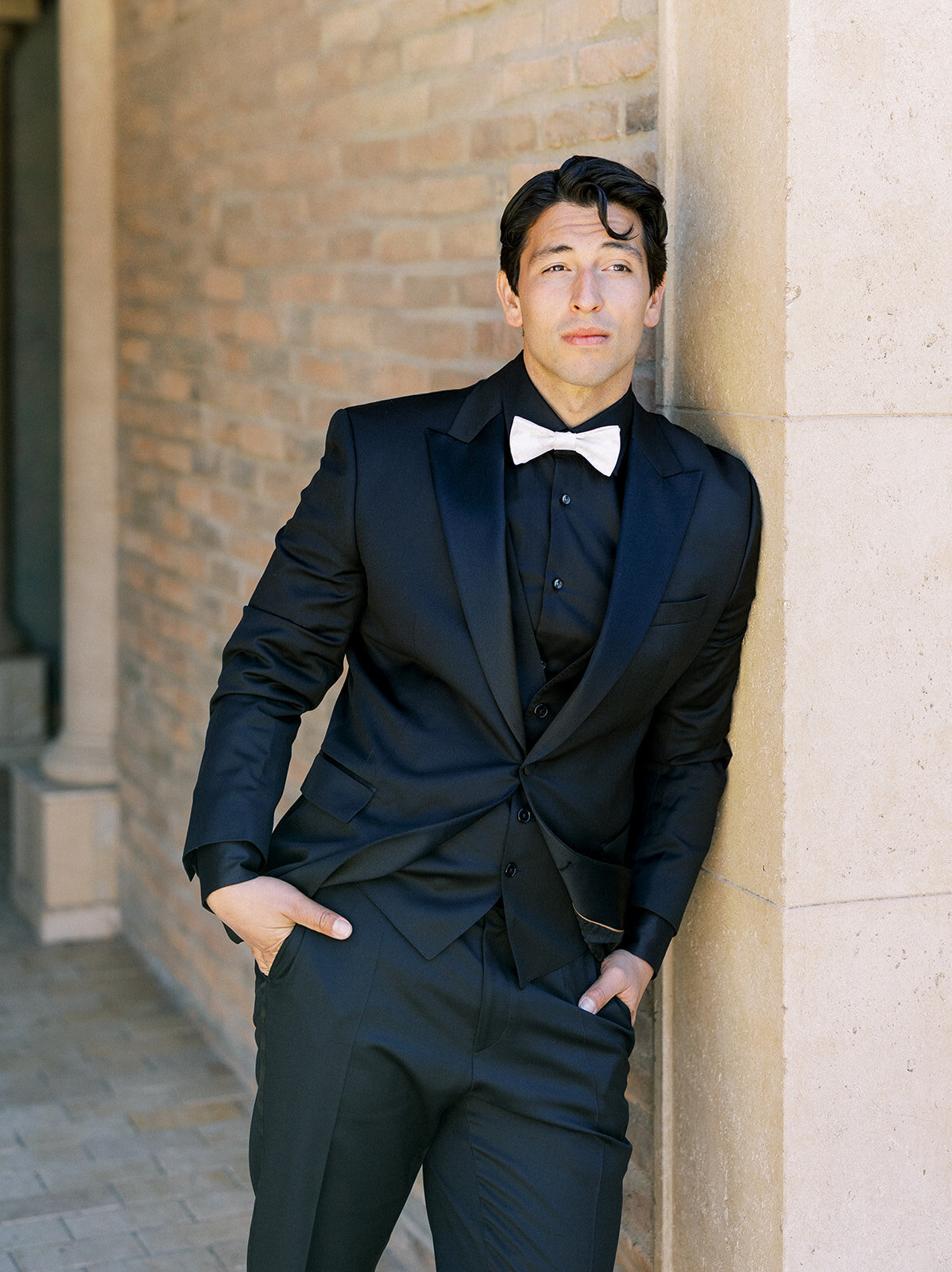 Groom smiles before the ceremony wearing an elegant black tux at allegretto resort and spa in Paso Robles, California during his luxury wedding day