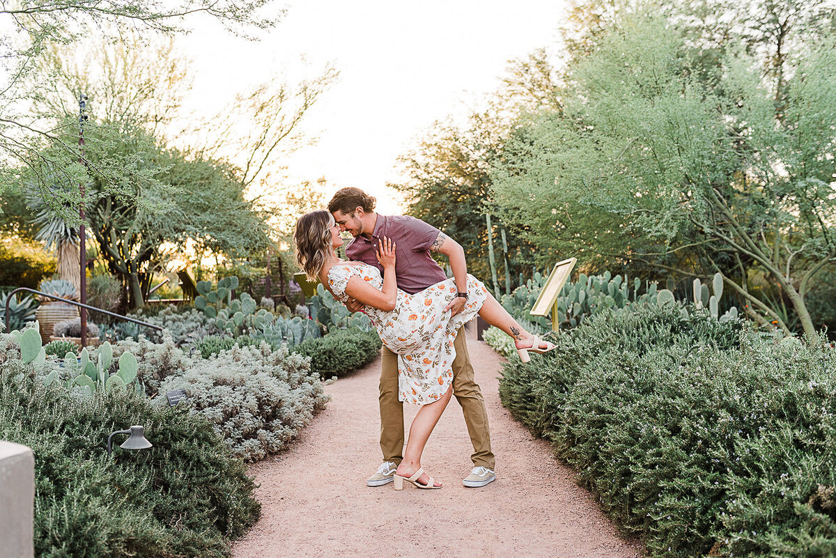 couple engagement photo dipping at desert botanical gardens
