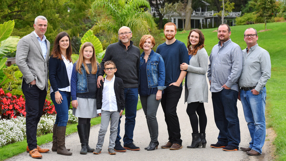 multi-generational-family portrait everyone wearing casual jeans and grey