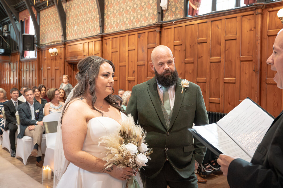 Bride and groom exchanging vows in Worsley Court House ceremony room.