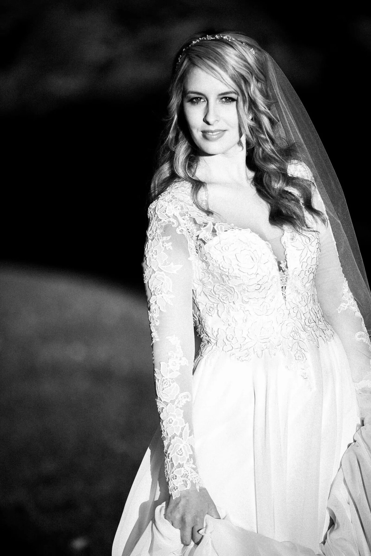 Black and white photo of light shining on a bride