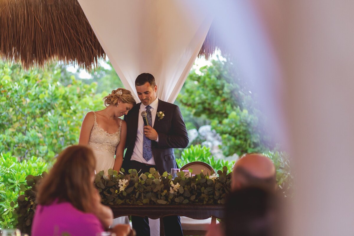 Grooms speaking with bride beside her at Cancun wedding