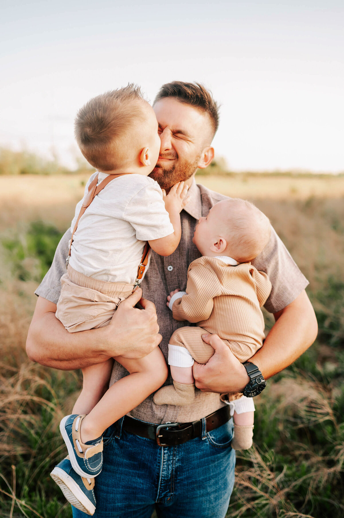 son kissing dad on cheek in family pictures in Branson MO