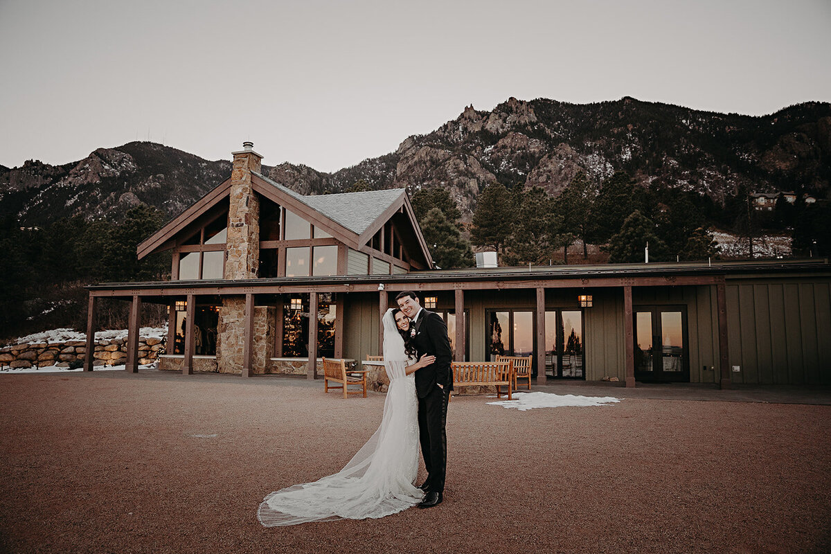 Couple kisses outside of the Broadmoor in Colorado.