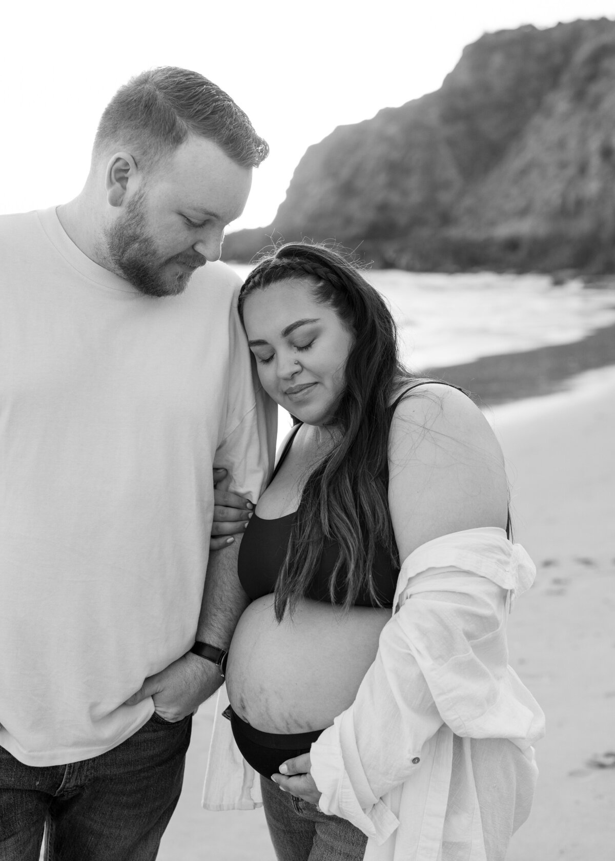 romantic black and white maternity photo on the beach